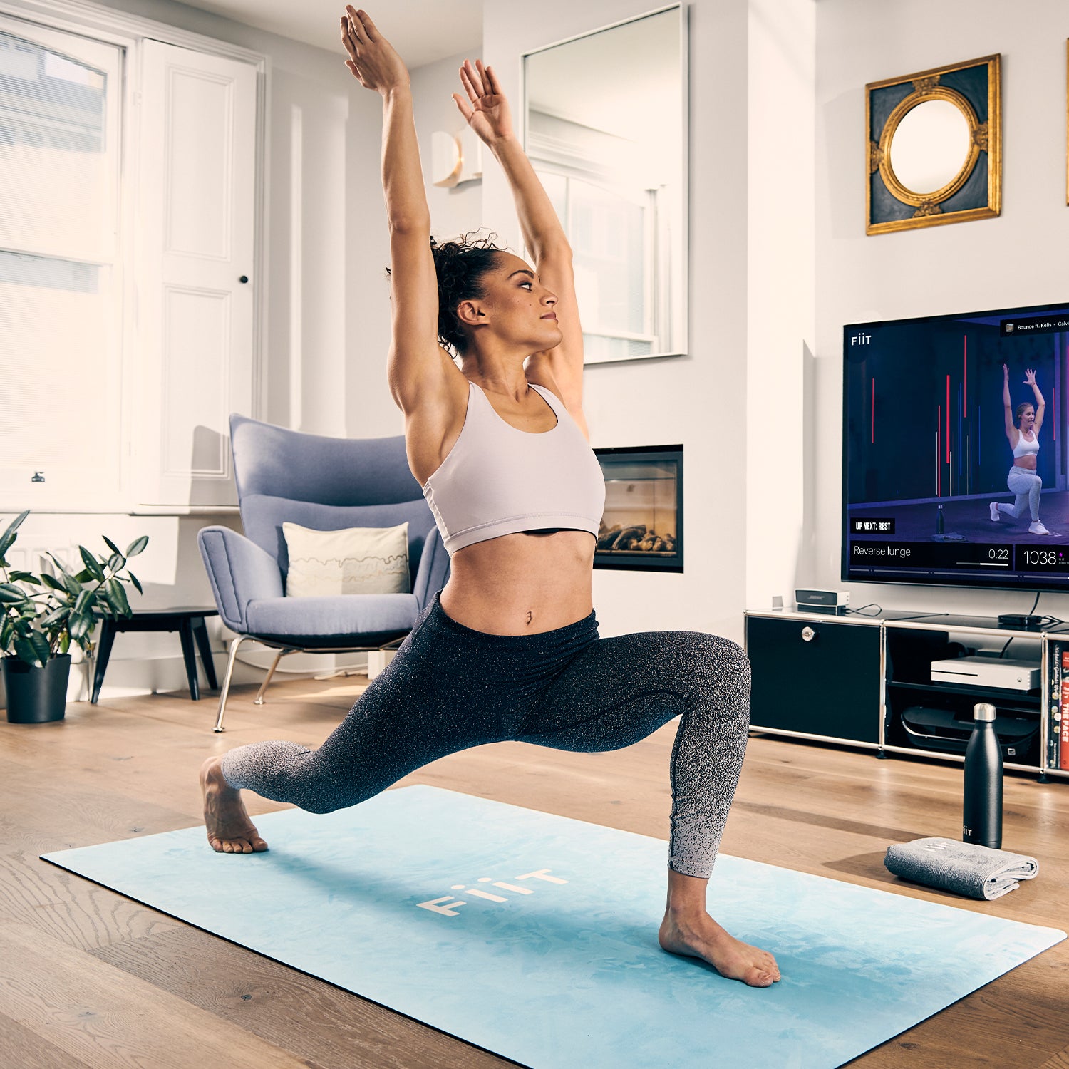 woman doing a lunge on light blue exercise and yoga mat
